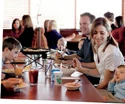 Family sitting around a table at Boston Pizza.